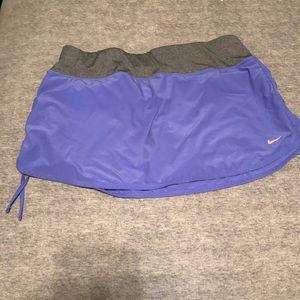 Purple nike dri fit skirt with orange shorts